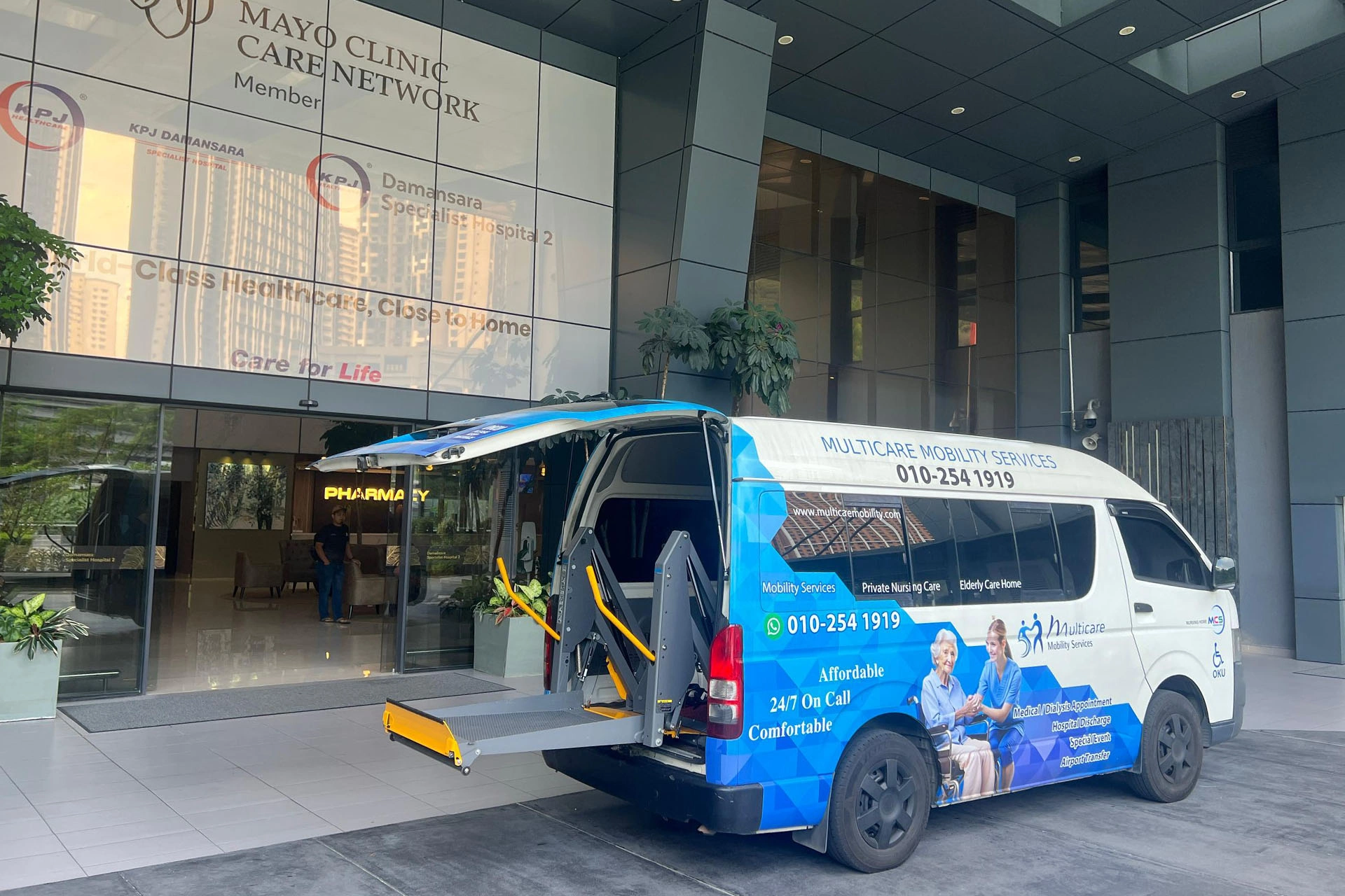 Multicare wheelchair-accessible van at a hospital entrance